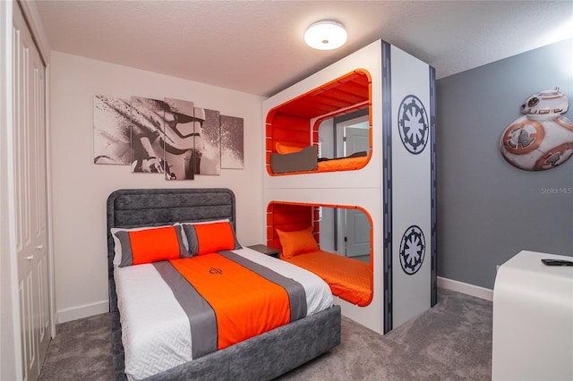 carpeted bedroom featuring a closet and a textured ceiling