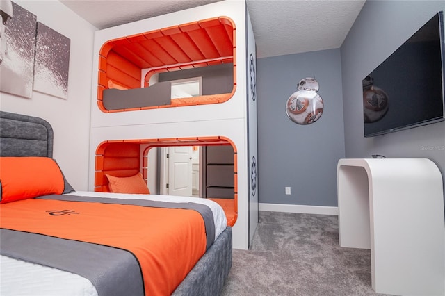 bedroom with a textured ceiling and carpet floors