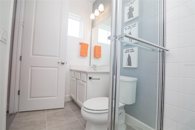 bathroom featuring tile flooring, walk in shower, vanity, and toilet