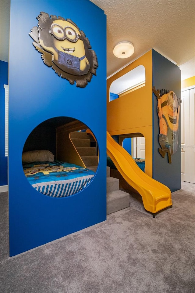 bedroom featuring carpet flooring and a textured ceiling