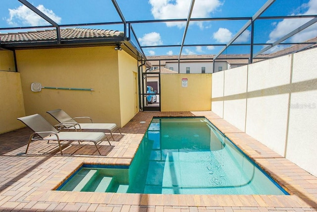 view of swimming pool featuring a patio area and a lanai