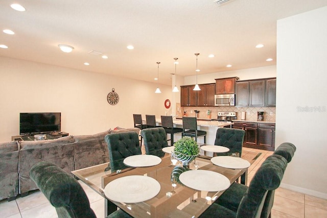 dining space featuring light tile patterned floors