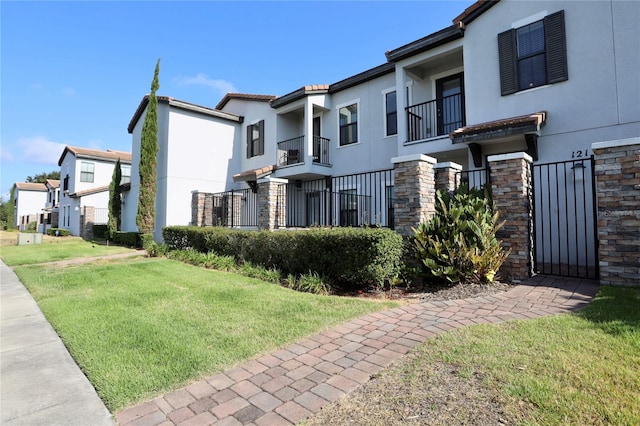 exterior space with a balcony and a lawn