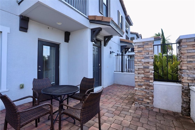 view of patio featuring a balcony