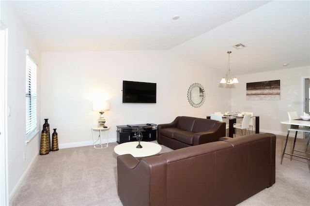 carpeted living room with vaulted ceiling and a notable chandelier