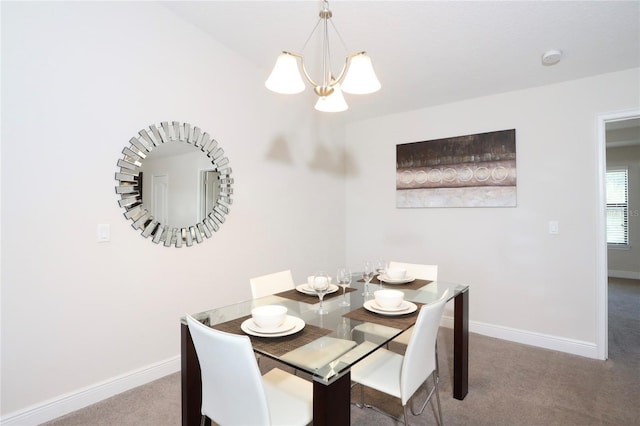 carpeted dining room featuring a chandelier