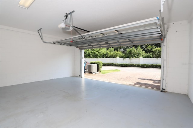 garage featuring central air condition unit and a garage door opener