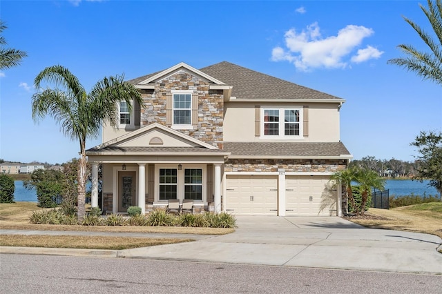 front of property featuring a garage and a water view