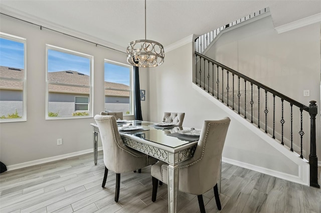 dining room featuring crown molding, an inviting chandelier, and light hardwood / wood-style floors