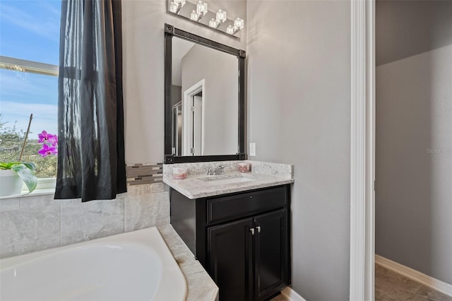 bathroom featuring vanity and a bath