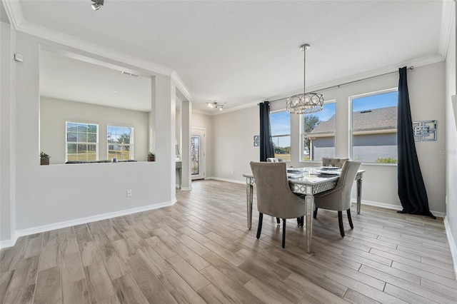 dining area with ornamental molding, light hardwood / wood-style floors, and a notable chandelier