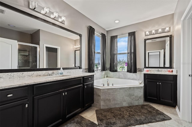 bathroom featuring vanity and plus walk in shower