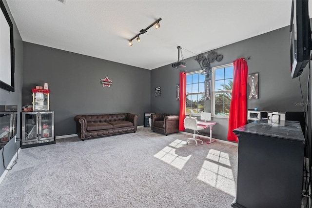 interior space with beverage cooler, light carpet, and rail lighting