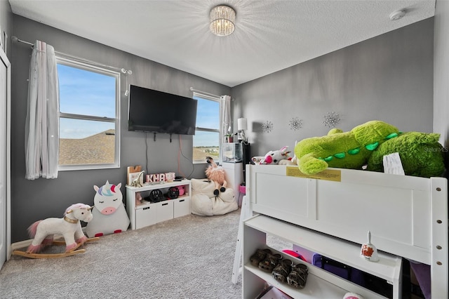 carpeted bedroom featuring a textured ceiling