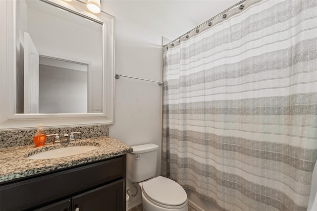 bathroom with walk in shower, vanity, and toilet