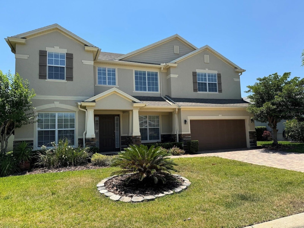 view of front facade with a front yard and a garage