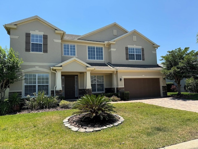 view of front facade with a front yard and a garage