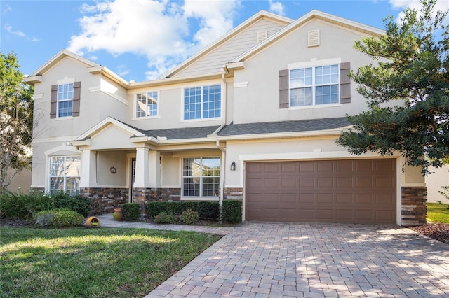 view of front of home featuring a front lawn and a garage