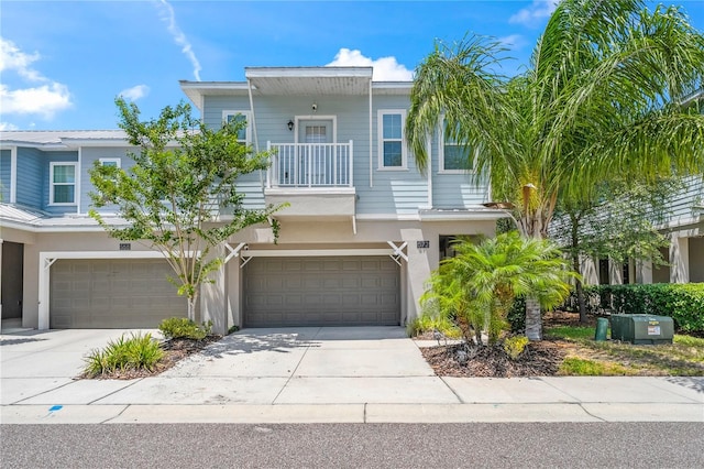 view of front of property featuring a garage and a balcony