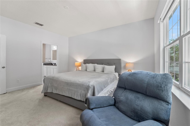 carpeted bedroom with ensuite bath