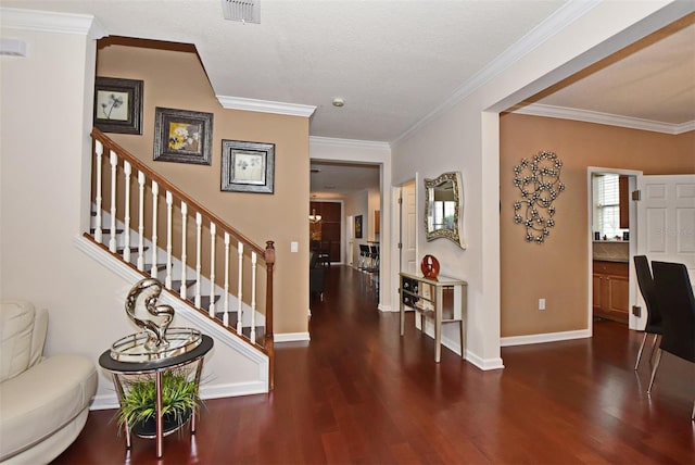 entrance foyer featuring a textured ceiling, dark wood-type flooring, and ornamental molding