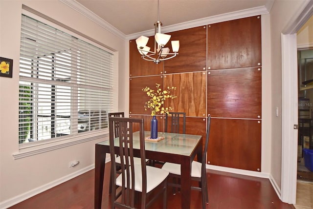 dining area featuring crown molding, hardwood / wood-style floors, and a notable chandelier