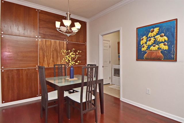 dining space featuring dark wood-type flooring, crown molding, and a chandelier