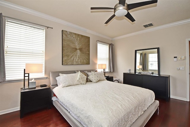 bedroom with crown molding, dark wood-type flooring, and ceiling fan