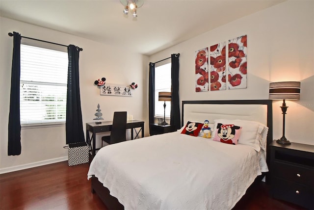 bedroom with dark wood-type flooring