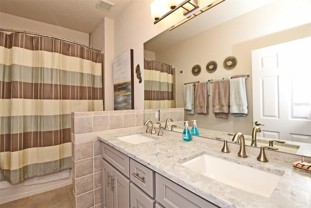 bathroom featuring double vanity and tile flooring