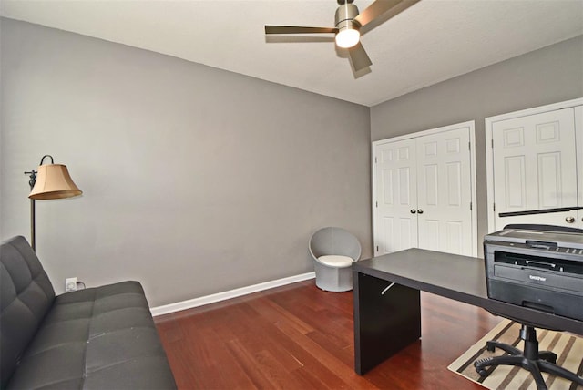 office area with dark wood-type flooring and ceiling fan