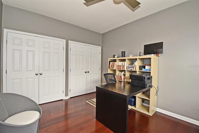 office with dark hardwood / wood-style flooring and ceiling fan