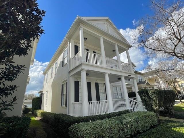 view of side of home with a balcony