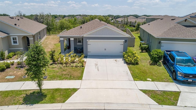 ranch-style home with a garage and a front lawn