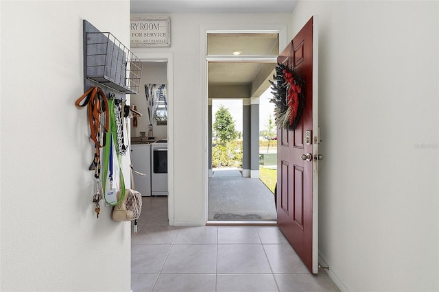 tiled entrance foyer featuring washer and dryer