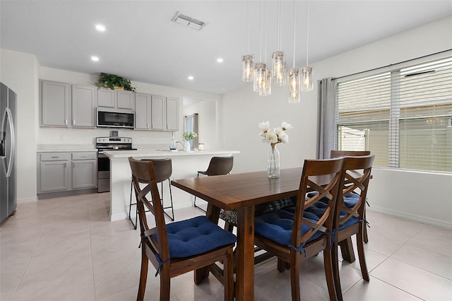 tiled dining area featuring a notable chandelier