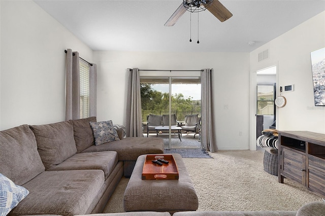 living room featuring carpet and ceiling fan