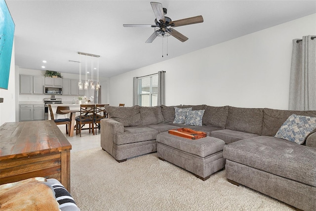 living room featuring light carpet and ceiling fan