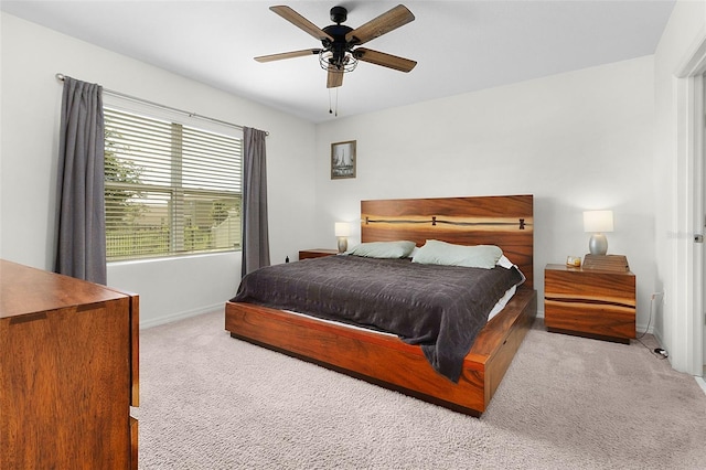 bedroom with ceiling fan and light colored carpet