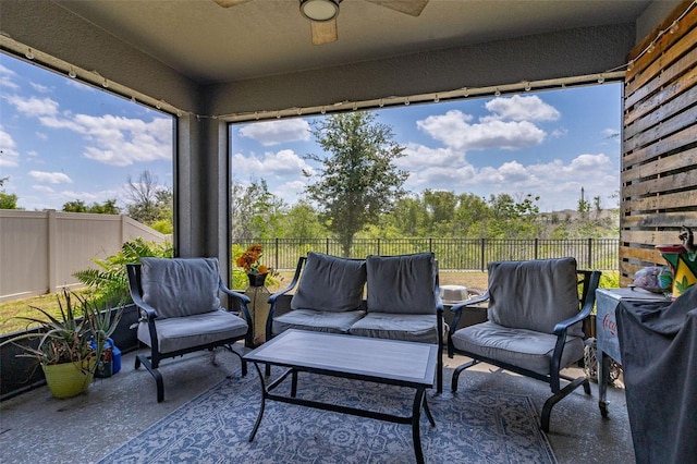 sunroom featuring ceiling fan