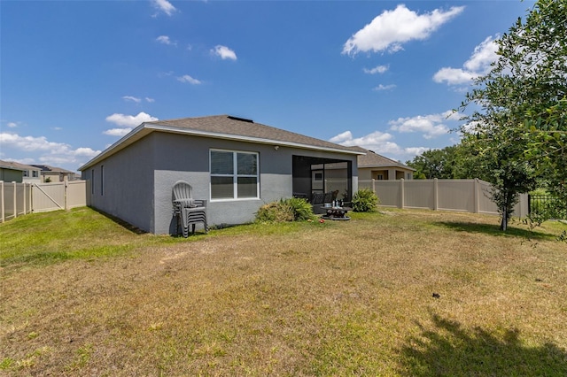 rear view of house with a lawn