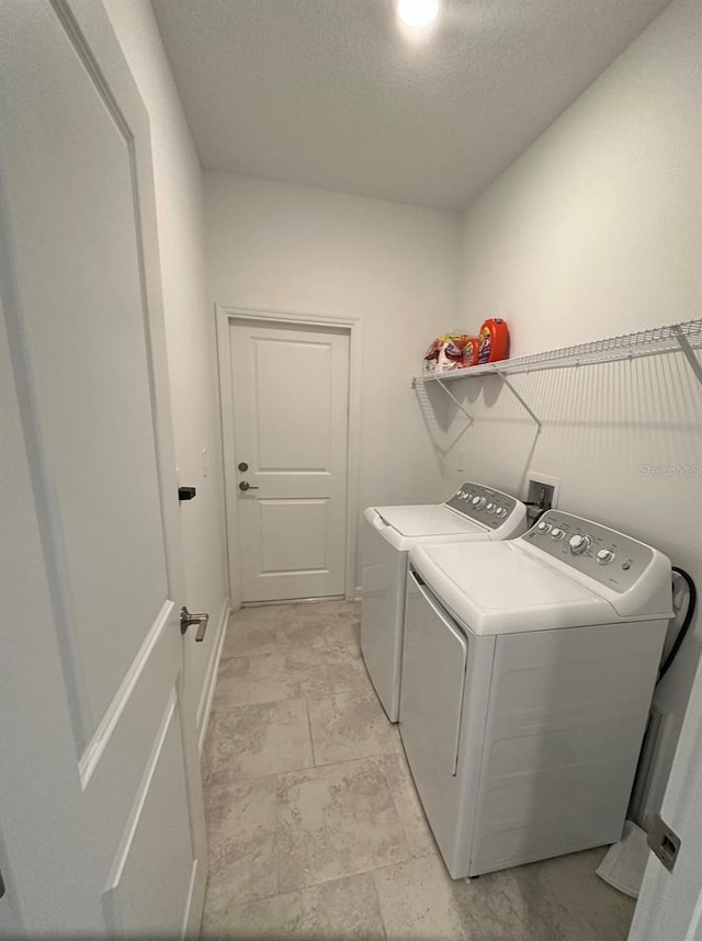 laundry room featuring hookup for a washing machine, light tile floors, and washer and clothes dryer