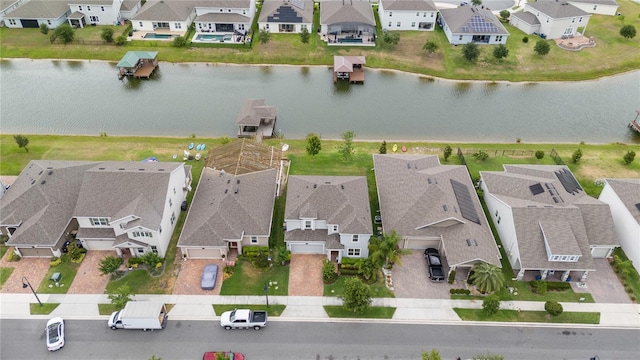 drone / aerial view with a residential view and a water view