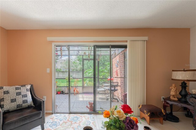 doorway to outside featuring a textured ceiling and tile patterned floors