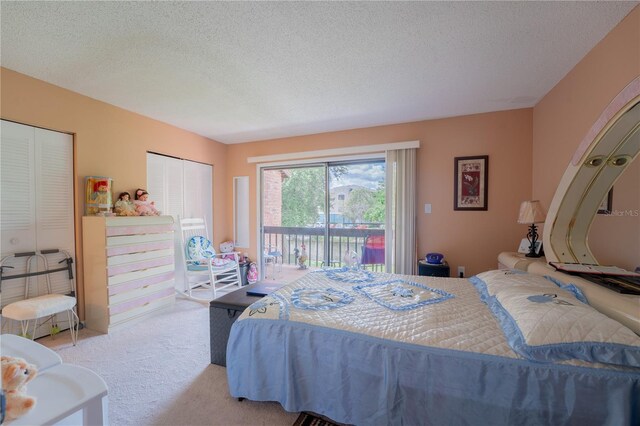 bedroom featuring a textured ceiling, access to exterior, a closet, and carpet floors