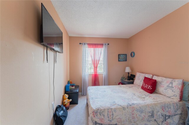 carpeted bedroom with a textured ceiling