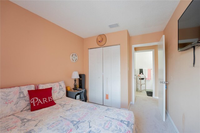 bedroom with a closet and carpet floors