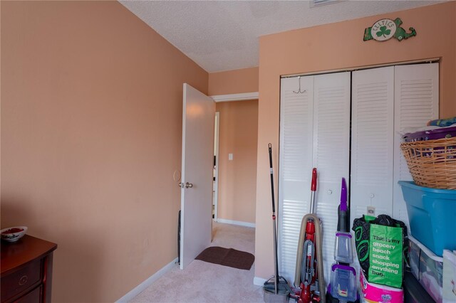 bedroom with a closet, a textured ceiling, and carpet