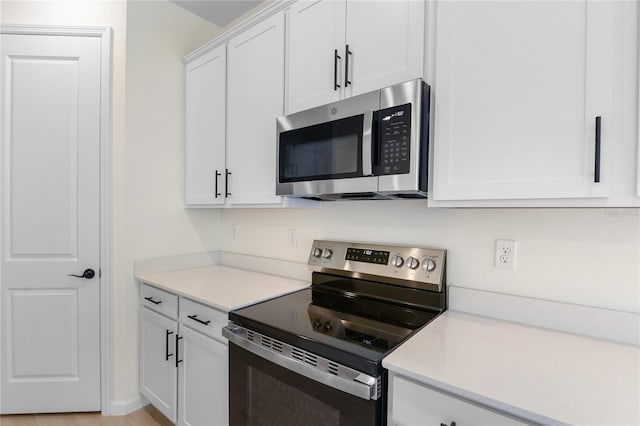 kitchen featuring white cabinetry and stainless steel appliances