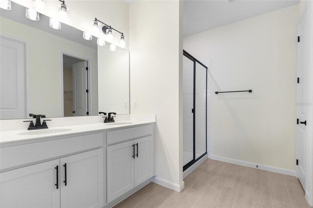 bathroom with walk in shower and vanity